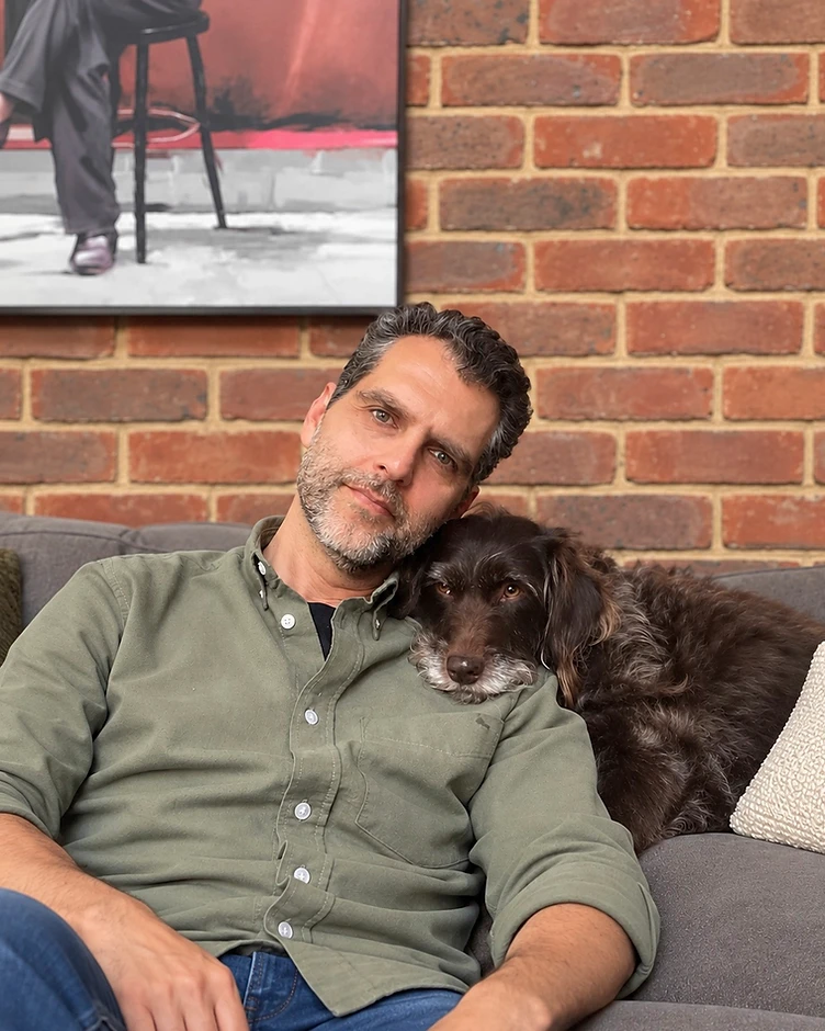 Udi with Belle, a man with his dog