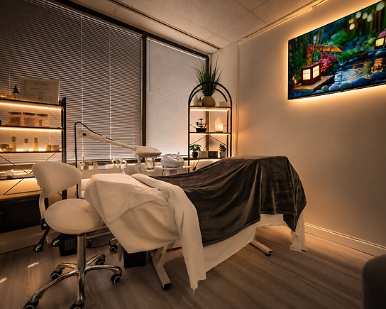 Prepared treatment room with backlit shelving and warm lighting at Serenity Spa