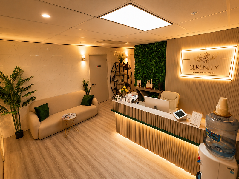 Reception lounge with the illuminated Serenity Health & Beauty Spa sign and living green wall