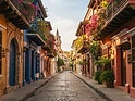 Colorful colonial street in Cartagena with flower-draped balconies