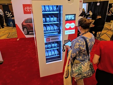White Toyota experiential kiosk with survey and redeem screen at a trade show on red carpet