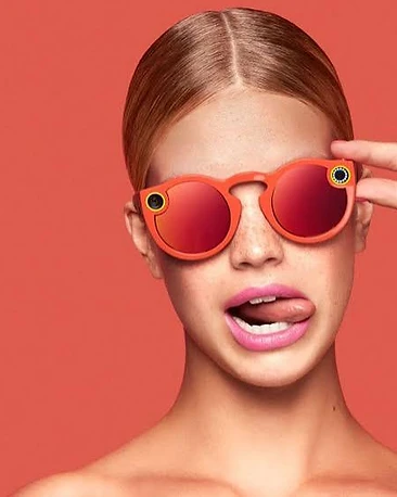 Editorial portrait of a person wearing Snapchat Spectacles camera glasses