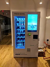 FRESH.BOWL connected food retail kiosk with a touchscreen displaying locally sourced meals