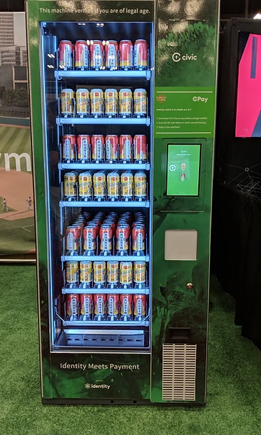 Forest-green age-verification vending machine with an identity tablet and ID-check interface