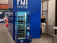 FIJI Water branded vending installation built into a blue exhibition wall