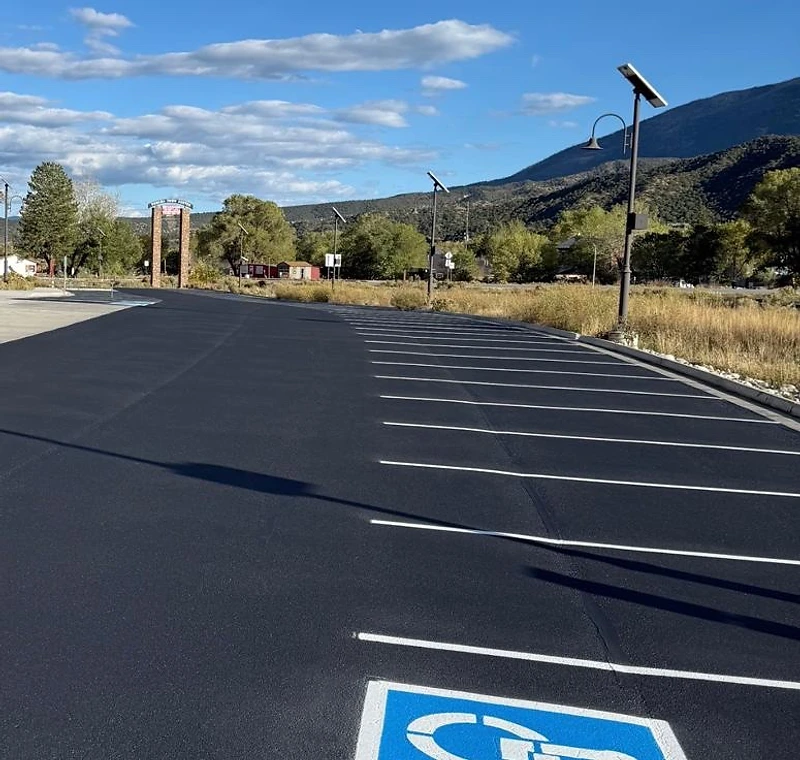 Freshly striped asphalt parking lot with handicap stall and mountain views near Buena Vista Colorado