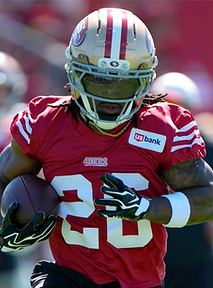 A 49ers running back carrying the football during practice