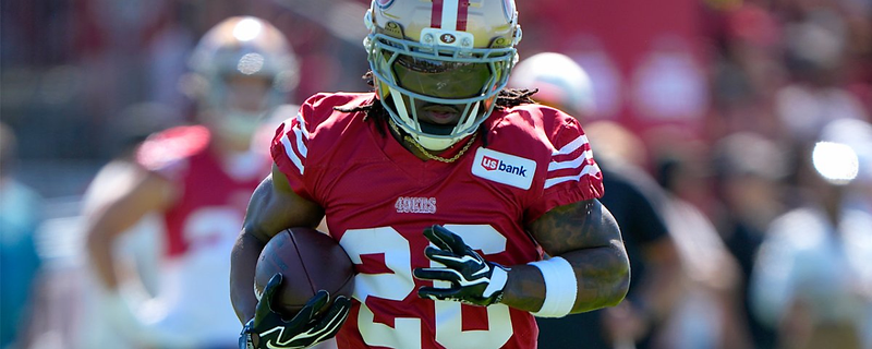 A 49ers running back carrying the football during practice