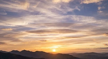 Layered atmospheric skies at sunset — not to scale.