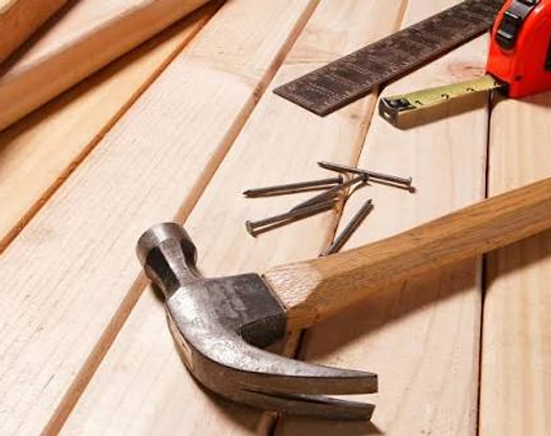 Woodworking tools resting on light wooden planks