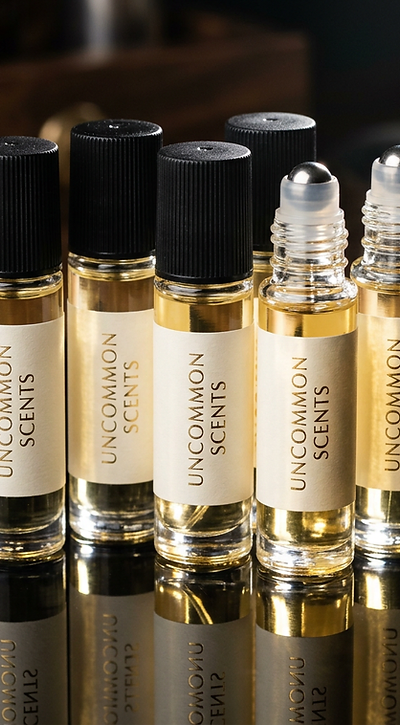 Five Uncommon Scents roller bottles arranged as a bundle