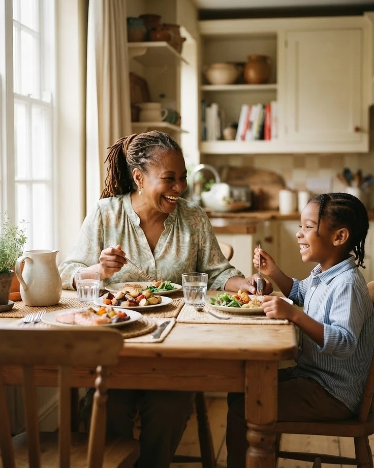 An African American grandmother and her grandson sharing lunch at home in warm natural light
