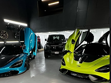Two McLarens and a Defender in the shop