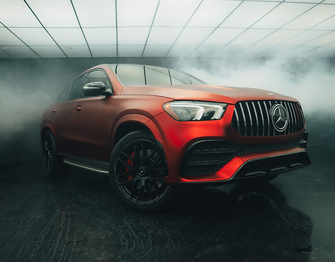 Matte red Mercedes-AMG SUV in studio fog