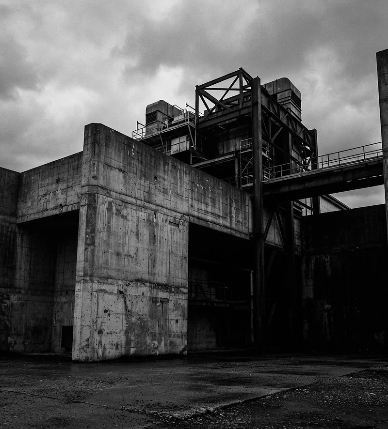 Raw concrete wall against a heavy overcast sky