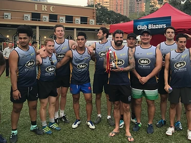 The Club Blazers touch team holding the trophy in front of the Club Blazers branded tent at King Park, Hong Kong