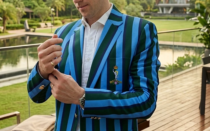 Custom striped blazer with sky blue and teal vertical stripes, featuring an embroidered crest and gold buttons