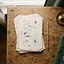 A stack of printed pages on a wooden table beside a pencil