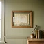 A plain framed certificate on a painted wall