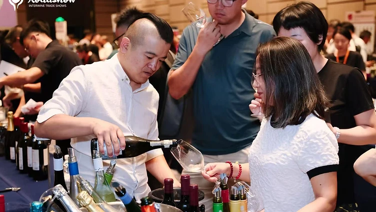 Wine professionals discussing market distribution and KPIs at a B2B wine trade event in China