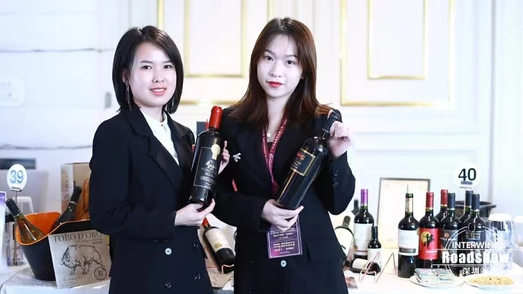 Professional wine buyers reviewing technical tasting notes and negotiating supplier contracts at Interwine trade fair booth