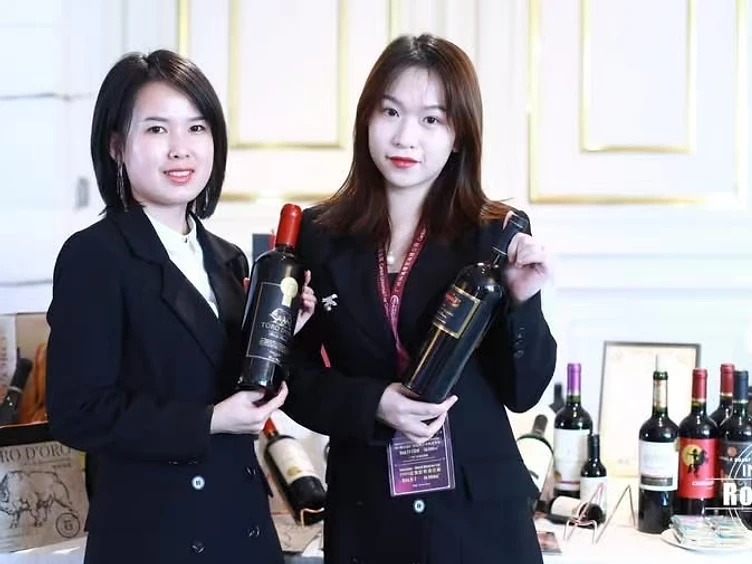 Professional wine buyers reviewing technical tasting notes and negotiating supplier contracts at Interwine trade fair booth