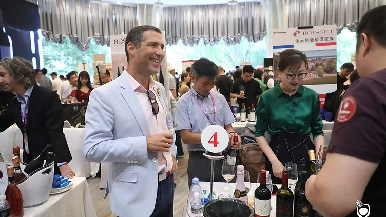 Professional wine and spirits buyers at registration desk entering the Interwine exhibition hall