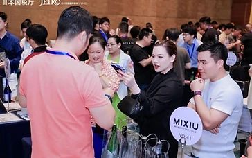 International winery sourcing director reviewing technical wine sheets and tasting samples at a B2B wine trade show booth