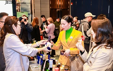 Bilingual wine tech sheets and Chinese-language tasting notes displayed on a winery exhibition table in China
