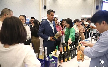 Hotel beverage director and sommelier reviewing wine bottles and list economics in a luxury hotel cellar