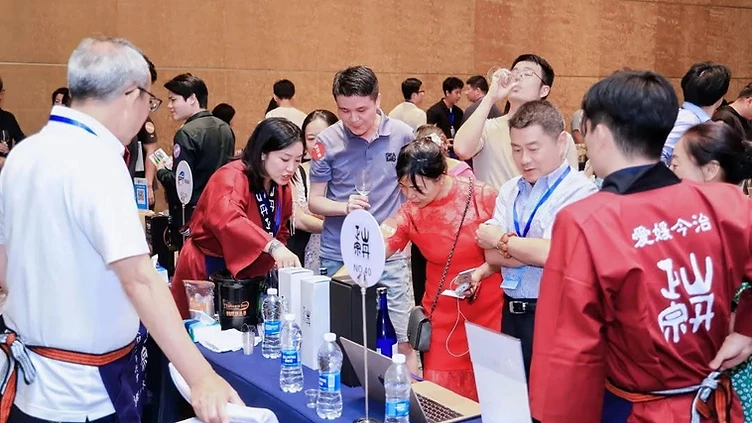 Boutique wine producer presenting bottles at an Asian wine exhibition stand