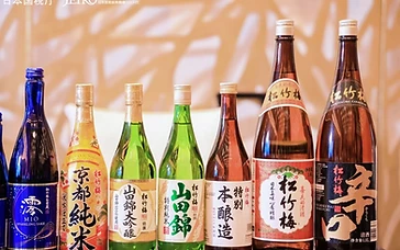 Professional wine and spirits buyers evaluating wine bottles and technical sheets at a commercial trade exhibition booth.