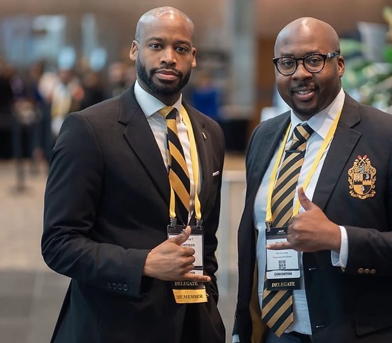 Two brothers of Rho Chi Lambda Chapter in Alpha colors at the General Convention