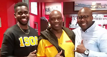 Brothers gathered indoors wearing chapter colors