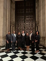 Brothers and sisters posing before grand historic doors
