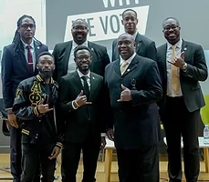 Brothers in suits at a community panel discussion on civic engagement
