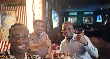 Brothers sharing a toast at a London pub