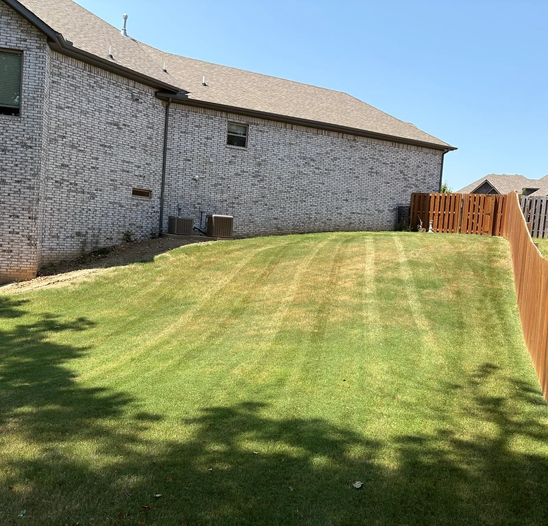 Perfectly striped lawn in Rogers, Arkansas after professional mowing service