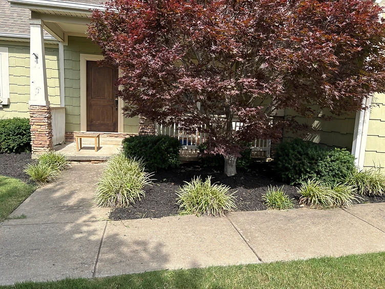 Shaw's Lawn Service crew caring for a yard in Northwest Arkansas