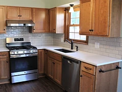 Finished kitchen remodel with custom wood cabinetry and quartz countertops