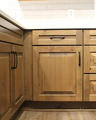 Detail of custom cabinetry showing recessed-panel doors and oil-rubbed bronze hardware