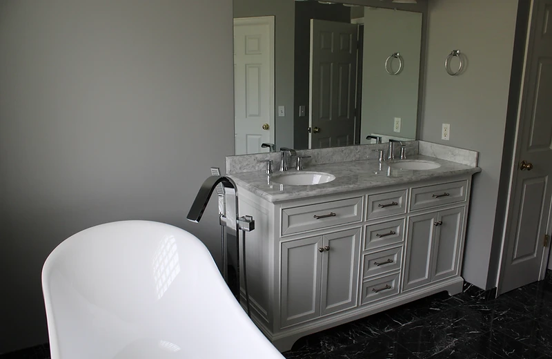 Finished bathroom remodel with freestanding tub and double vanity