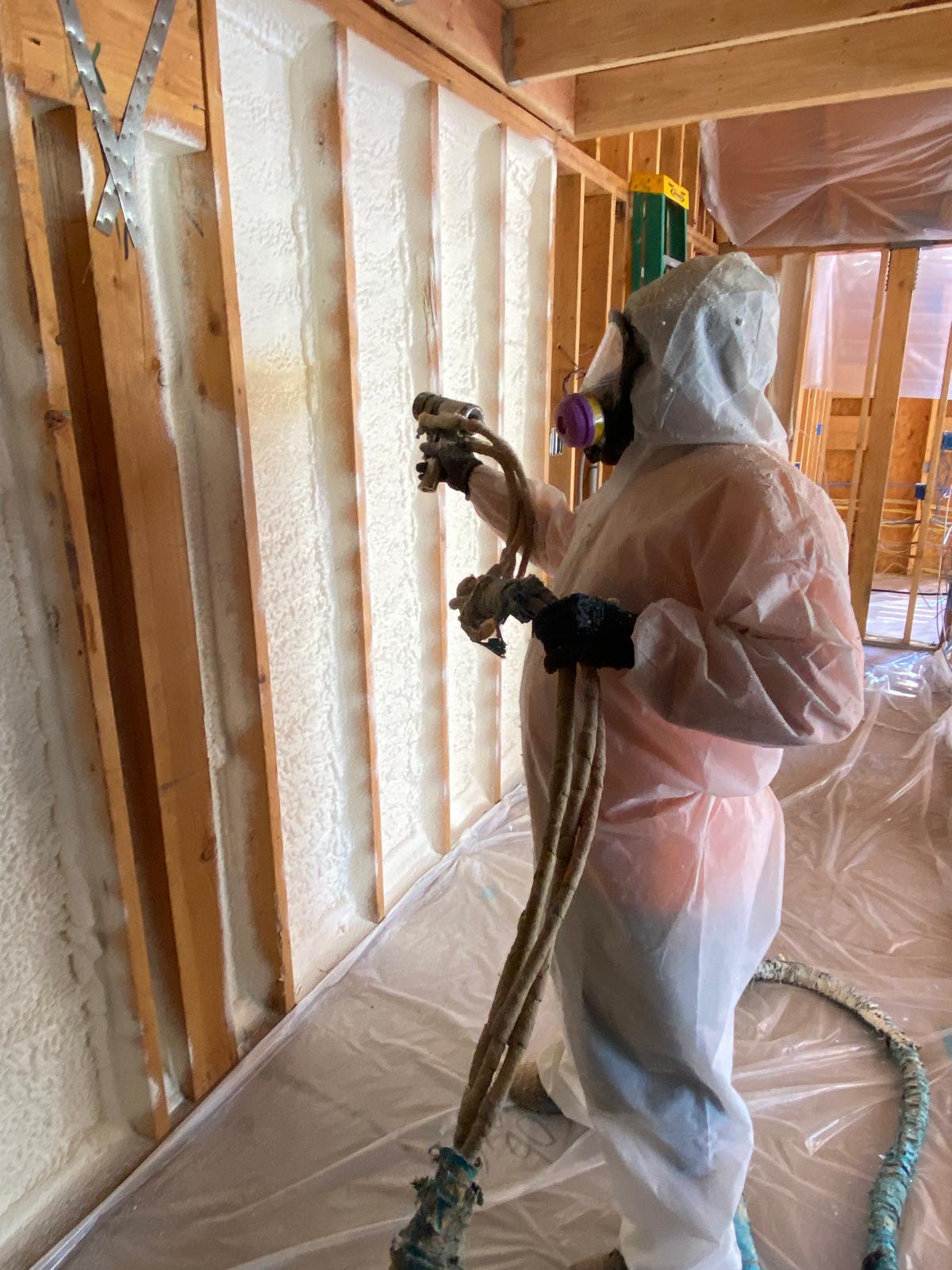 Spray foam insulation professional at work