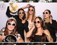 Bridal party posing with props at a photo booth