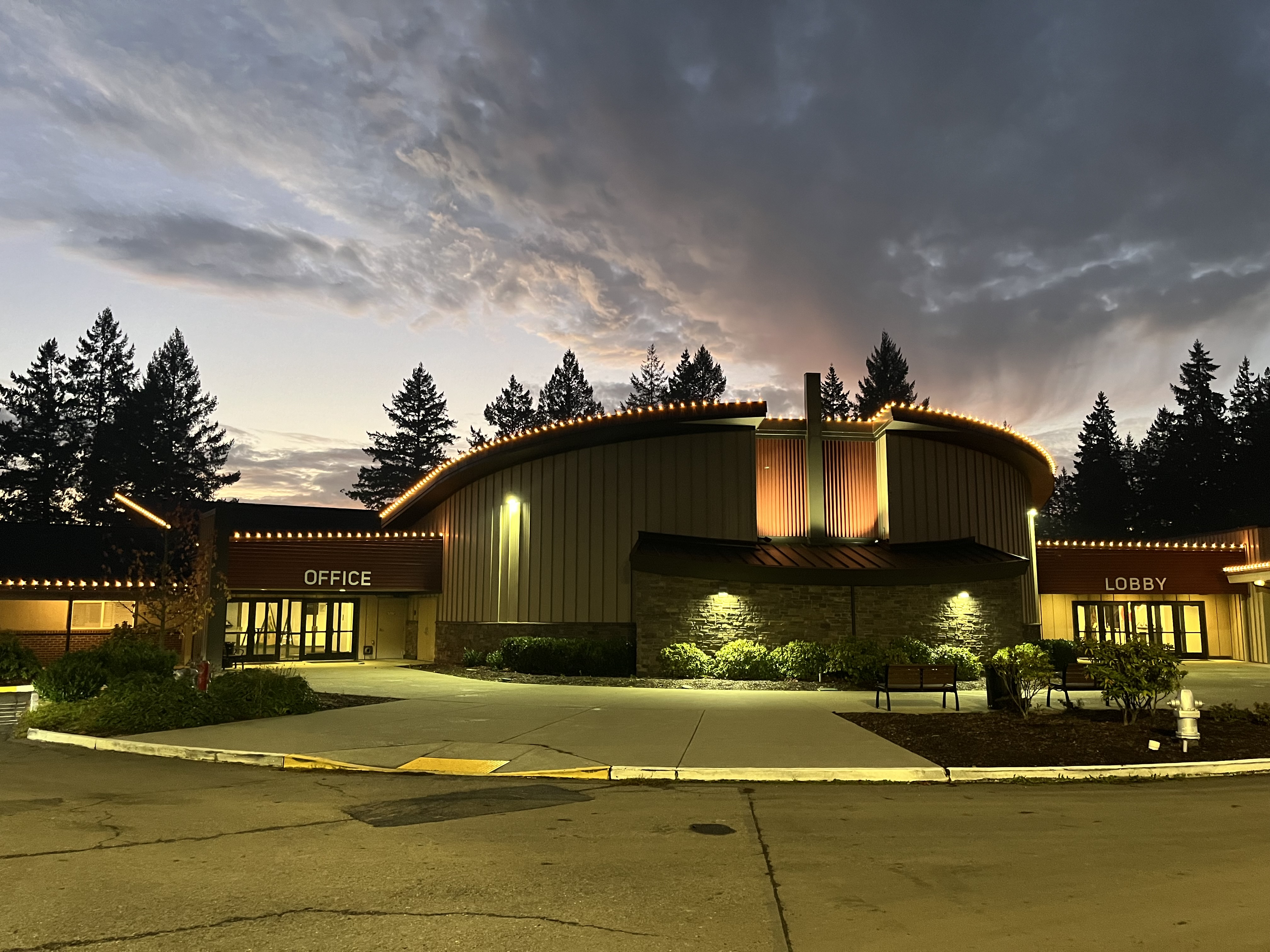 Building with warm C9 roofline lighting at dusk