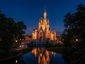 Themed landmark at dusk glowing with warm lights