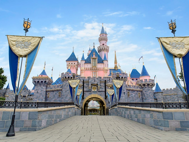 Sleeping Beauty Castle at Disneyland with royal banners on the bridge