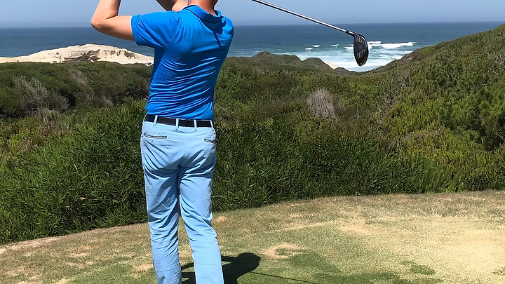 Manuel Baldauff teeing off on a coastal links golf course