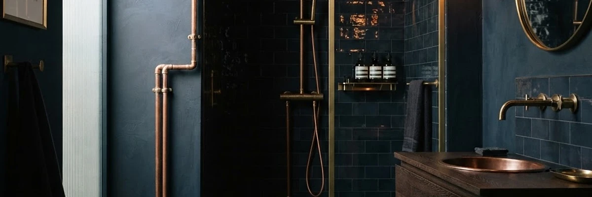 Atlas Plumbing Co. elegant dark bathroom with copper pipework