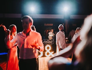 Dansvloer met gasten en LC Lennert achter de DJ-booth